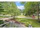 Charming home nestled on a lush corner lot, complete with an American flag, beautiful landscaping, and mature trees at 7209 St Ledger Dr, Raleigh, NC 27613