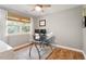 A home office featuring hardwood floors, neutral paint, and plenty of natural light at 7209 St Ledger Dr, Raleigh, NC 27613