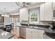 Bright kitchen featuring stainless steel appliances, granite countertops, and wood floors at 7209 St Ledger Dr, Raleigh, NC 27613