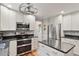 Modern kitchen featuring stainless steel appliances, granite countertops, and white cabinetry at 7209 St Ledger Dr, Raleigh, NC 27613