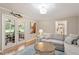 Cozy living room with French doors, hardwood floors, comfortable seating, and lots of natural light at 7209 St Ledger Dr, Raleigh, NC 27613