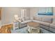 Comfortable living room featuring a gray sectional sofa, hardwood floors, and neutral walls at 7209 St Ledger Dr, Raleigh, NC 27613