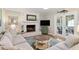 Inviting living room with a brick fireplace, comfortable sofa, and access to the outdoor patio at 7209 St Ledger Dr, Raleigh, NC 27613