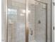 Tiled shower with glass doors and modern fixtures at 7209 St Ledger Dr, Raleigh, NC 27613
