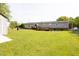 Spacious backyard featuring a long, covered deck, partially fenced yard and storage shed at 764 Olivers Grove Rd, Four Oaks, NC 27524