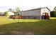 Large backyard with a wooden deck, partial fence, and storage shed at 764 Olivers Grove Rd, Four Oaks, NC 27524