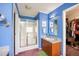Bathroom featuring a standing shower with glass enclosure, wood vanity, and walk-in closet at 764 Olivers Grove Rd, Four Oaks, NC 27524