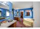 Bright bathroom boasts blue walls, dual vanities, soaking tub, and walk-in closet access at 764 Olivers Grove Rd, Four Oaks, NC 27524