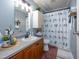 Well-organized bathroom with wood vanity and decorative shower curtain at 764 Olivers Grove Rd, Four Oaks, NC 27524