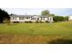Charming single-story home with a well-manicured lawn and an American flag at 764 Olivers Grove Rd, Four Oaks, NC 27524