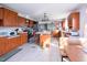 Expansive kitchen with wood cabinetry, stainless steel appliances, a center island, and ample counter space for cooking at 764 Olivers Grove Rd, Four Oaks, NC 27524