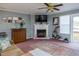 Living room with a fireplace, rug, and sliding glass door to the outside at 764 Olivers Grove Rd, Four Oaks, NC 27524