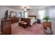 Serene bedroom features a wood bed, matching dresser, and soft lighting, creating a relaxing retreat at 764 Olivers Grove Rd, Four Oaks, NC 27524