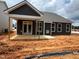 The backyard features a covered patio, complementing the home's exterior with a seamless blend of indoor-outdoor living at 798 Old Station Pointe, Angier, NC 27501