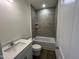 Clean bathroom with modern fixtures, neutral paint, and tiled shower and tub at 798 Old Station Pointe, Angier, NC 27501