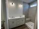 Bathroom with dual sinks, quartz countertops, and a tile shower with a bench at 798 Old Station Pointe, Angier, NC 27501