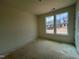 Bright bedroom with two large windows offering outside views of new homes in a Gathering-friendly neighborhood at 798 Old Station Pointe, Angier, NC 27501
