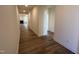 Hallway featuring wood floors leading to the open floor plan and main living area at 798 Old Station Pointe, Angier, NC 27501
