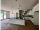 Bright, spacious kitchen featuring white cabinets, a large island, and modern pendant lighting at 798 Old Station Pointe, Angier, NC 27501