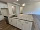 Kitchen island with a stainless steel sink and granite countertops at 798 Old Station Pointe, Angier, NC 27501