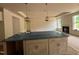 Kitchen island with modern pendant lights overlooking the bright, spacious living area with fireplace at 798 Old Station Pointe, Angier, NC 27501