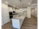 Bright kitchen featuring an island with granite countertops and stainless appliances at 798 Old Station Pointe, Angier, NC 27501
