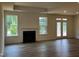 Bright living room with fireplace, wood floors, and a glass door to the outside at 798 Old Station Pointe, Angier, NC 27501