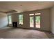 Bright living room with fireplace, large windows and french doors opening to backyard, showcasing open living space at 798 Old Station Pointe, Angier, NC 27501