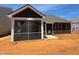 A rear view of the home featuring a screened in porch and outdoor living space at 798 Old Station Pointe, Angier, NC 27501