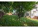 The backyard features mature landscaping and a privacy fence at 8701 Erinsbrook Dr, Raleigh, NC 27617
