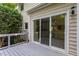 Grey deck features sliding glass doors, shrubbery, and wood railings at 8701 Erinsbrook Dr, Raleigh, NC 27617