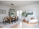 Bright dining room with a stylish light fixture, wood table, and neutral decor at 8701 Erinsbrook Dr, Raleigh, NC 27617
