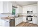 Well-lit kitchen with stainless steel appliances and white cabinetry at 8701 Erinsbrook Dr, Raleigh, NC 27617