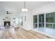 Open-concept room with a fireplace, lots of natural light and a sliding glass door at 8701 Erinsbrook Dr, Raleigh, NC 27617