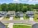 Aerial view of suburban neighborhood featuring well-maintained homes and verdant landscaping at 9120 Dupree Meadow Dr, Angier, NC 27501