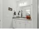 Bright bathroom featuring a framed mirror, white vanity, and gray countertop offering a clean, modern aesthetic at 9120 Dupree Meadow Dr, Angier, NC 27501