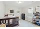 Well-lit bedroom with a dark wood bed frame and a dresser next to a window at 9120 Dupree Meadow Dr, Angier, NC 27501