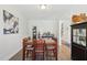 Bright dining room featuring stylish decor and a view into the hallway with wood floors at 9120 Dupree Meadow Dr, Angier, NC 27501