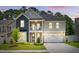Charming two-story home with a welcoming front porch, beautiful landscaping, and two-car garage at 9120 Dupree Meadow Dr, Angier, NC 27501