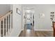 Hallway view shows the staircase and entry point into the home. Neutral colors throughout at 9120 Dupree Meadow Dr, Angier, NC 27501
