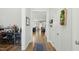 Inviting hallway with hardwood floors, showcasing an open floor plan leading to the kitchen and living area at 9120 Dupree Meadow Dr, Angier, NC 27501