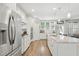 Stylish kitchen with stainless steel appliances, white cabinets, granite countertops and wood flooring at 9120 Dupree Meadow Dr, Angier, NC 27501