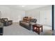 Spacious living room with a large sofa, TV and desk creating a comfortable and inviting gathering space at 9120 Dupree Meadow Dr, Angier, NC 27501