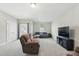 Spacious living room with a large sofa, and TV creating a comfortable and inviting gathering space at 9120 Dupree Meadow Dr, Angier, NC 27501