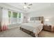 Main bedroom is spacious with tray ceilings, neutral carpet, and large window at 9120 Dupree Meadow Dr, Angier, NC 27501