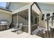 Covered screened patio with comfortable seating and an outdoor grill at 9120 Dupree Meadow Dr, Angier, NC 27501