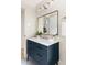 Bathroom featuring a blue vanity, white countertop, and gold fixtures at 939 Clarion Dr, Durham, NC 27705