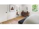 Bedroom featuring hardwood floors with an ensuite bathroom and wood dresser at 939 Clarion Dr, Durham, NC 27705