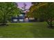 Two-story home showcasing an expansive green lawn and mature trees at 939 Clarion Dr, Durham, NC 27705