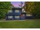 Charming two-story home featuring a manicured lawn, brick facade, and a welcoming orange front door at 939 Clarion Dr, Durham, NC 27705